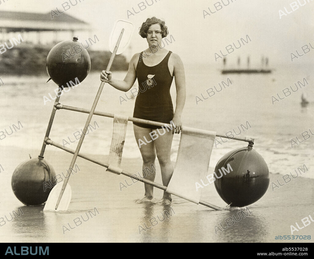 Gertrude Ederle (1906-2003), American Swimmer, full-length Portrait in one-piece swimsuit on beach, Underwood & Underwood, 1925.