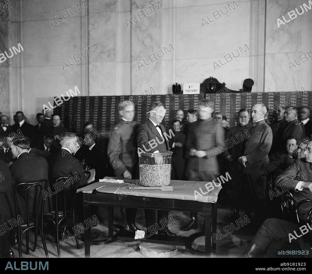HARRIS & EWING. Sec. of the Navy Josephus Daniels drawing draft capsules, between 1910 and 1920.