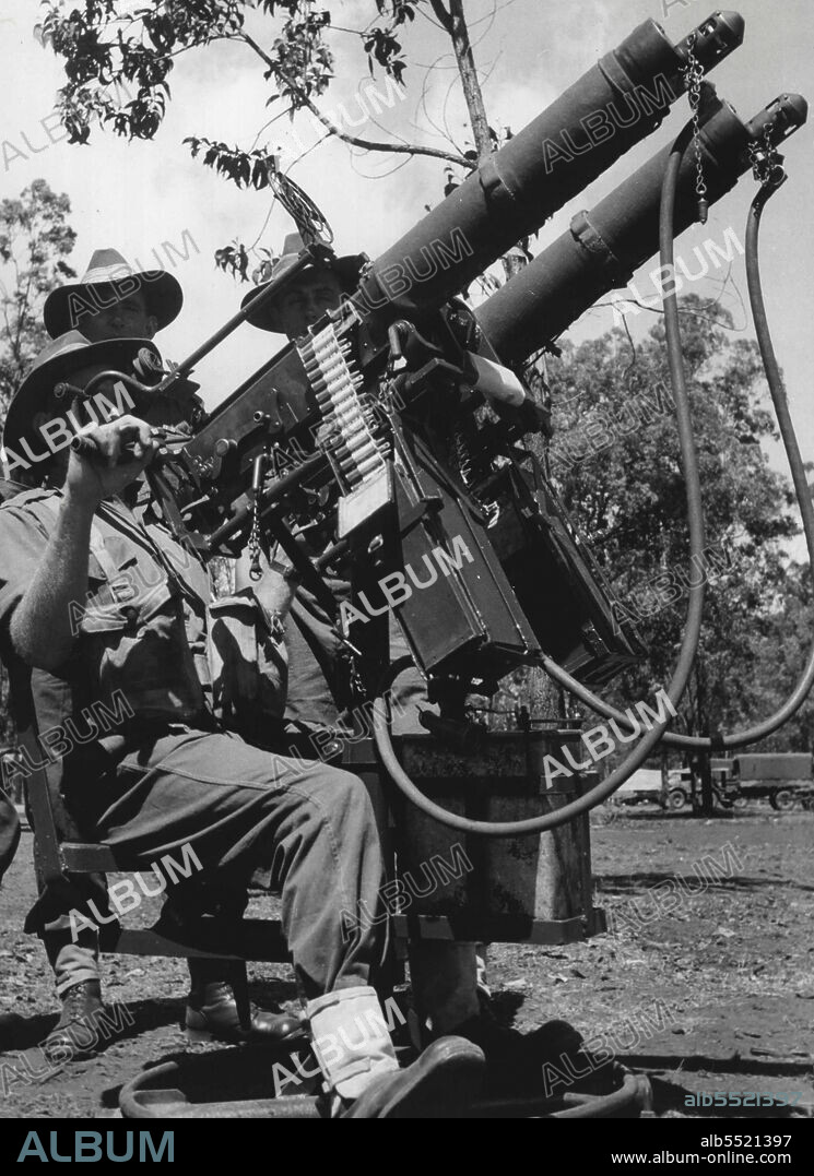 Members of a machine-gun unit man twin vickers on a radial ack-ack mounting. December 18, 1944. (Photo by Australian Official Photo).