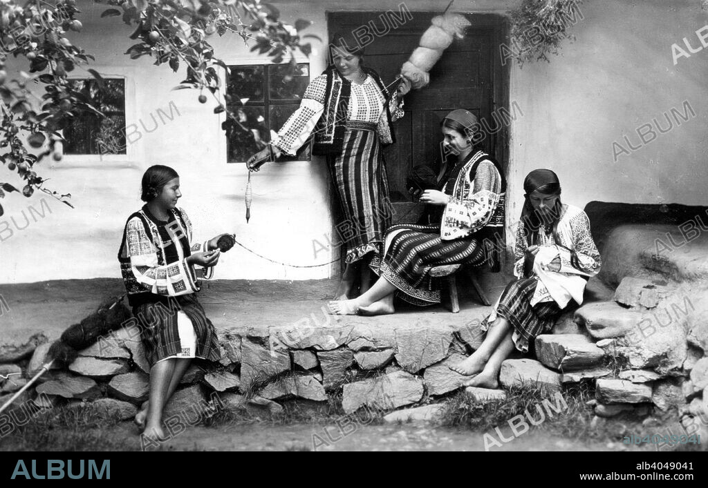 Young women spinning and sewing, Bistrita Valley, Moldavia, north-east Romania, c1920-c1945. Depicting customs and traditional labour in the rural Carpathian Mountains in the first half of the 20th century. The main occupations in this area were the timber industry and livestock farming. The local community were Orthodox Christians who led a very conservative lifestyle.