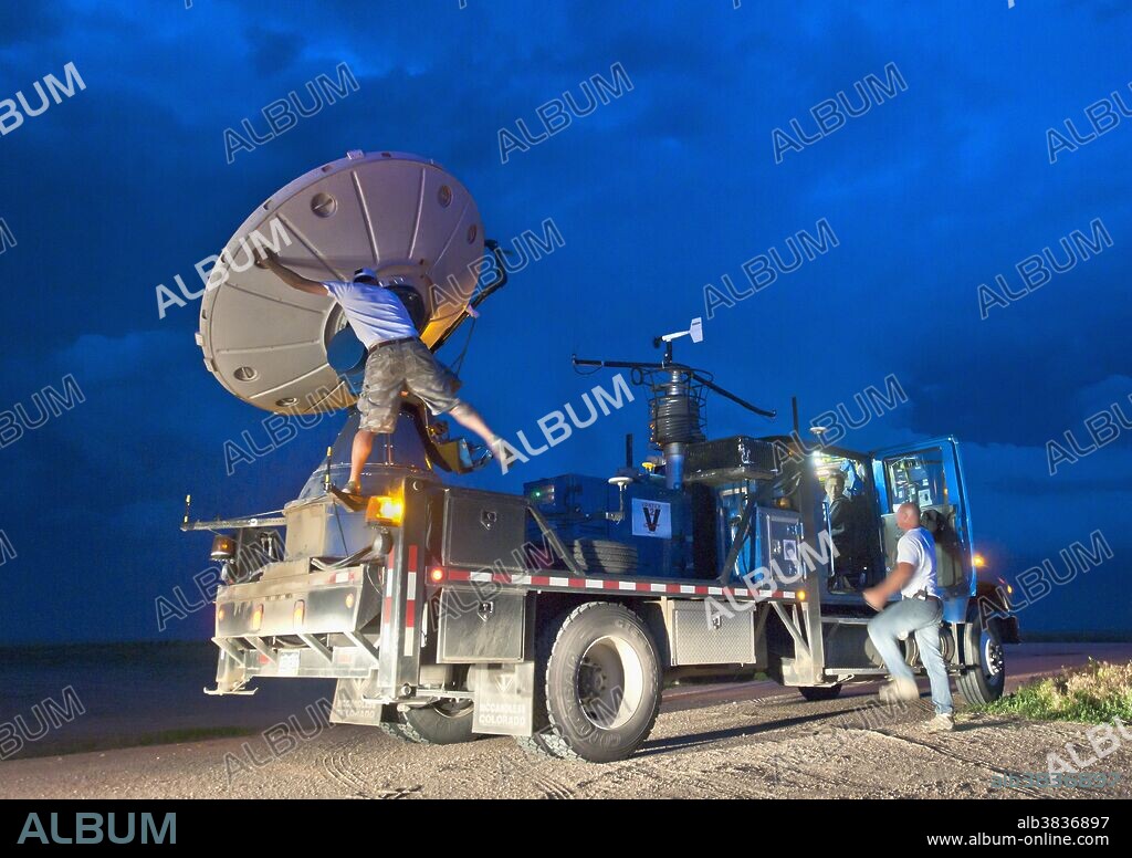 Tornado researcher Justin Walker adjusts the dish on a Doppler on Wheels (DOW) portable weather radar truck during a severe storm in eastern Colorado on June 10, 2010. More than 100 research vehicles, including the DOW, participated in VORTEX 2, an unprecedented two-year science project to study tornadoes in the United States in 2009 and 2010.