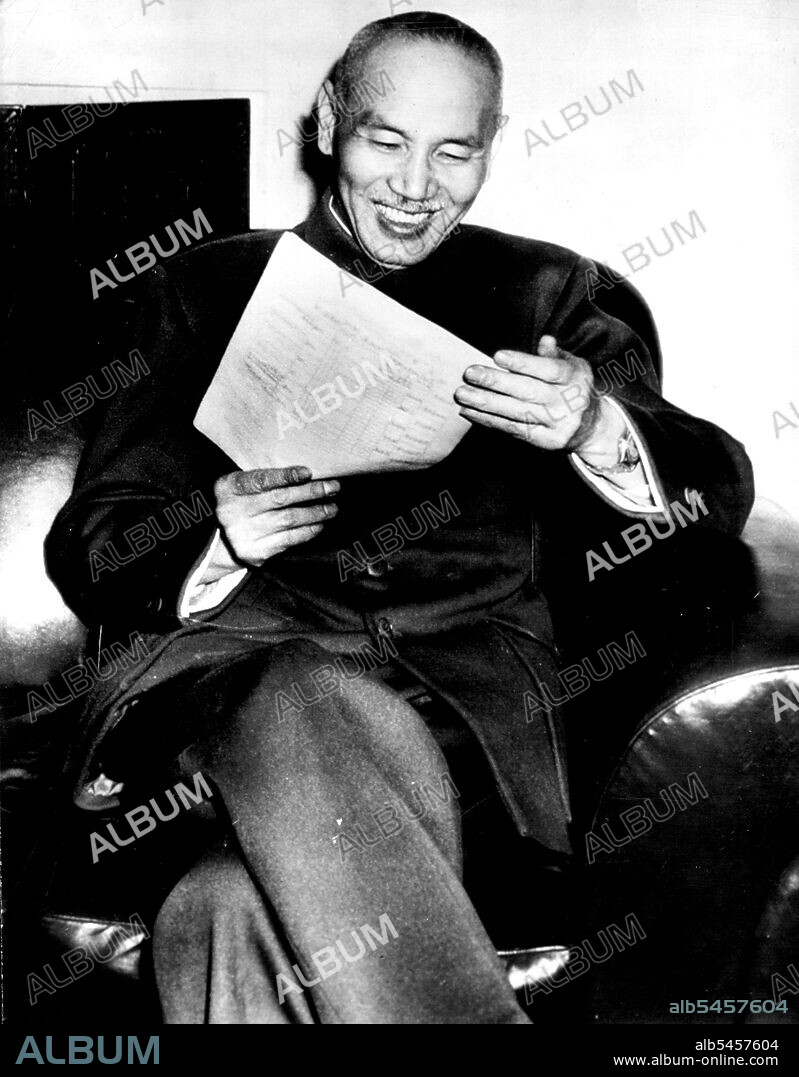 President Chiang Kai-Shek Pleased By Election -- Elected first constitutional President of China, Chiang Kai-Shek smiles with pleasure as he reads one of the many congratulatory messages received at his home in Nanking. This is the first photograph of Chiang Kai-Shek since his election. May 19, 1947. (Photo by John M. Hogan, AP Wirephoto).