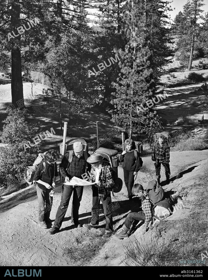 Montana: c. 1958 A family plots their route for a 12 day backpacking trip through the Bob Marshall Wilderness Area.