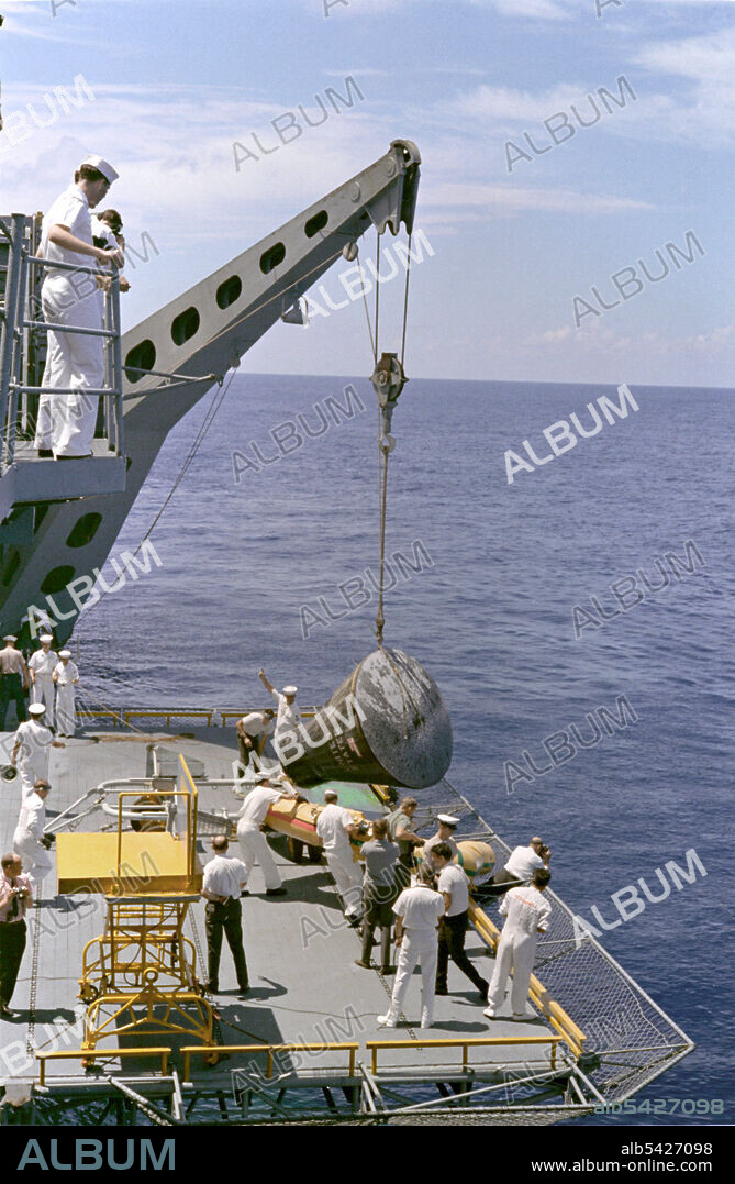 Gemini 5 capsule hoisted onboard recovery ship, 1965. The Gemini 5 spacecraft is brought aboard the recovery ship, U.S.S. Lake Champlain after a successful splashdown at the end of its mission.