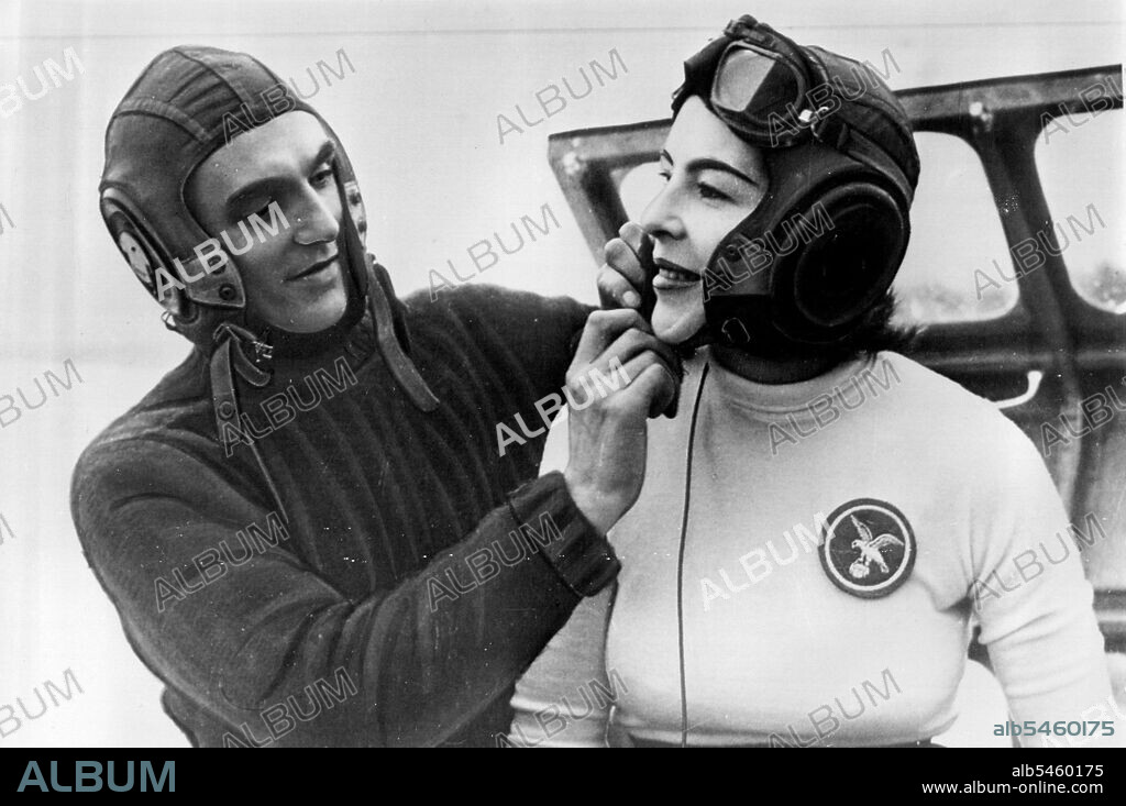 Ready For Water Speed Test - British Naval architect Frank Hanning-Lee helps adjust the helmet of his wife, Stella, before a speed trial run in their jet-powered hydrofoil speedboat Thursday on England's Lake Windermere. Mrs. Hanning-Lee may pilot the craft in an attempt to break the world's water speed record. British jet ace John Cobb in the explosion of his jet boat two weeks ago after setting a new mark of 206.89 miles an hour. October 11, 1952. (Photo by AP Wirephoto).