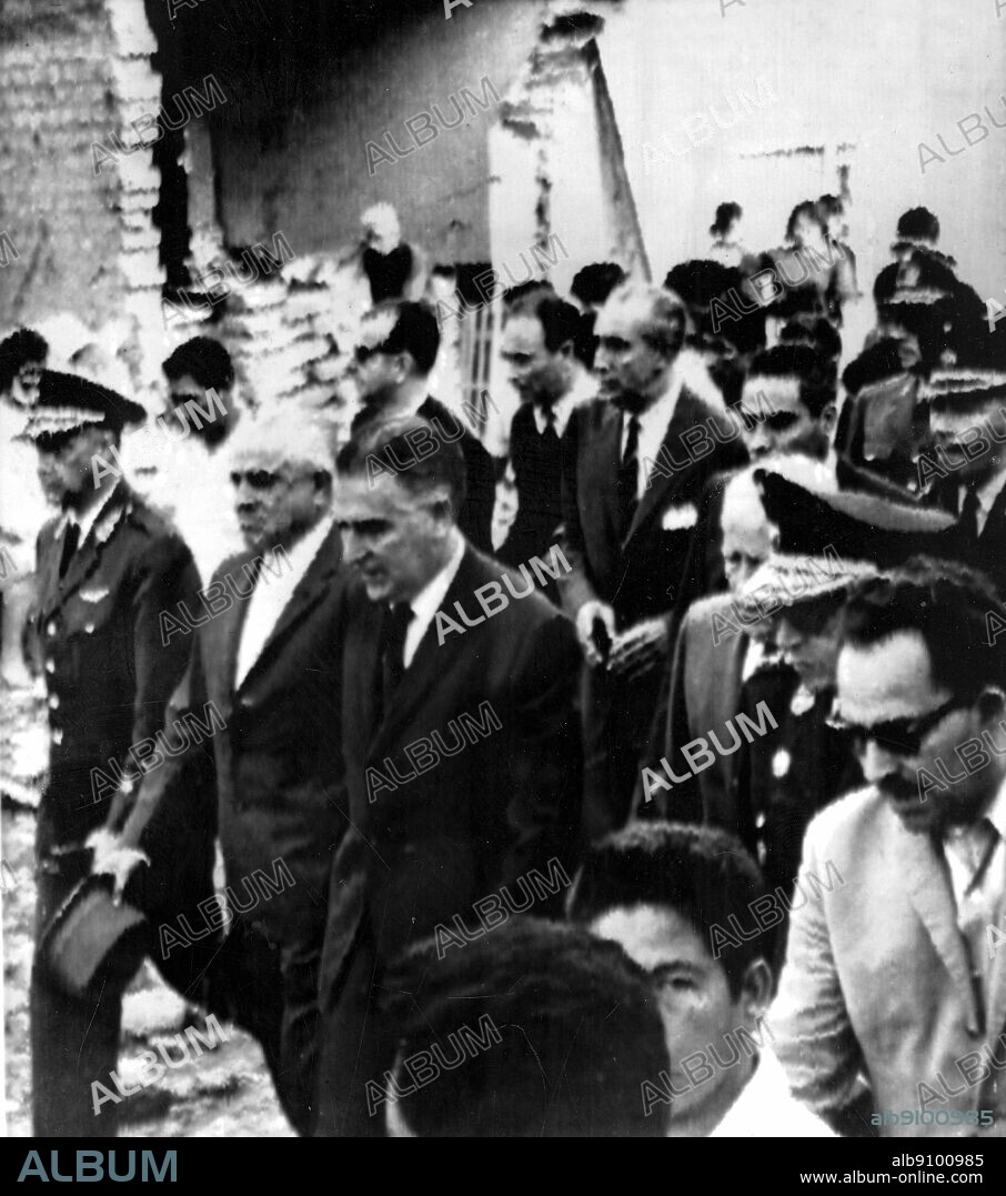 Lima, Perus, 19th October 1966: President Fernando Belaunde (centre, dark hair), visits the ruins of the city of Huacho, 120 km north of Lima. Escorted by local and national officials, the President toured the areas of Peru which were heavily damaged by an earthquake.