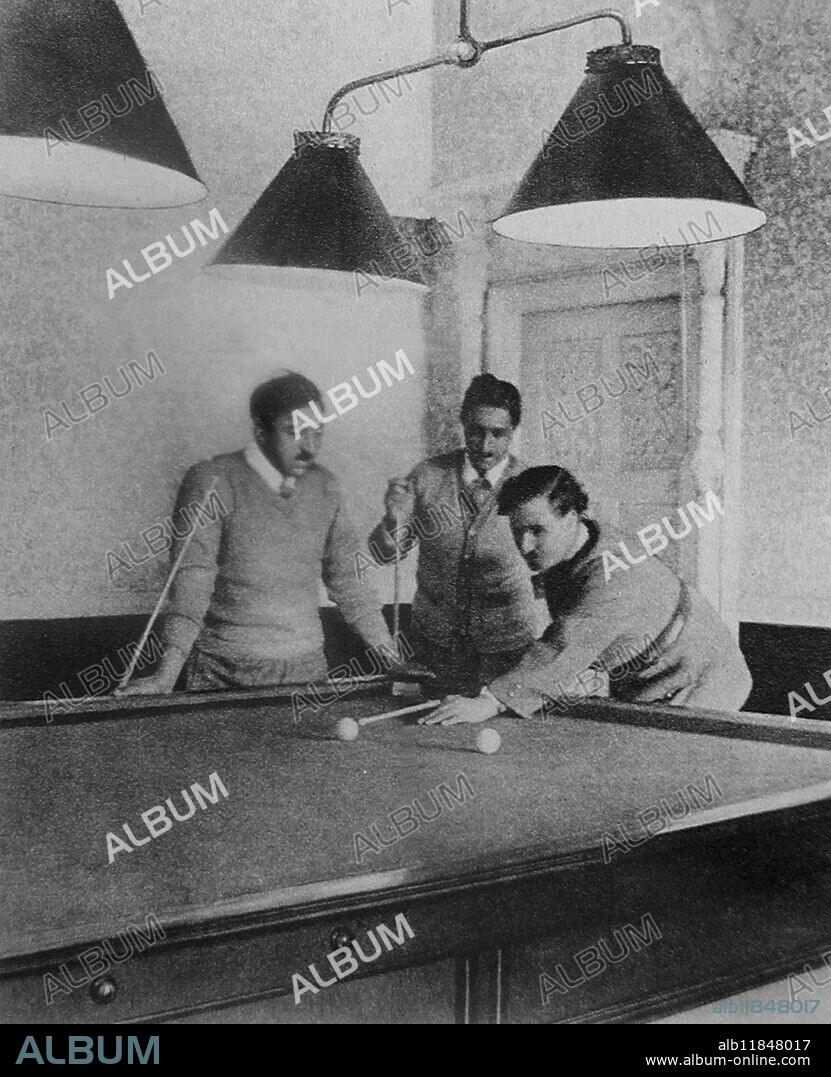 In the billiards room at the Royal Palace at Paghman; King Amanullah of Afghanistan (left) with his chamberlain and an officer of the court.
