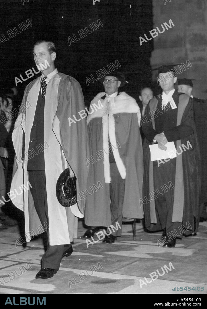 Duke of Edinburgh Receives Honorary Degree. Wearing his robes, the Duke of Edinburgh walks in procession from the schools Arcade to the senate House at Cambridge University, where he received the honorary degree of Doctor of Law. He also opened a new engineering laboratory, and in the evening was to receive honorary membership of the Union society, where he was to listen to a debate. November 13, 1952.