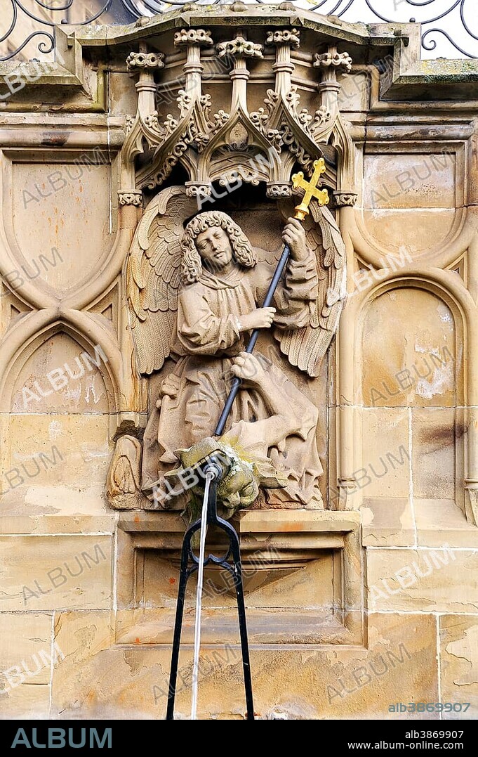 High-relief of St. Michael and the Dragon as a well figure on the Gothic Fischbrunnen fountain, built in 1509 by the Haller sculptor Hans Beuscher, Marktplatz square, Schwäbisch Hall, Baden-Wuerttemberg, Germany, Europe, PublicGround, Europe.