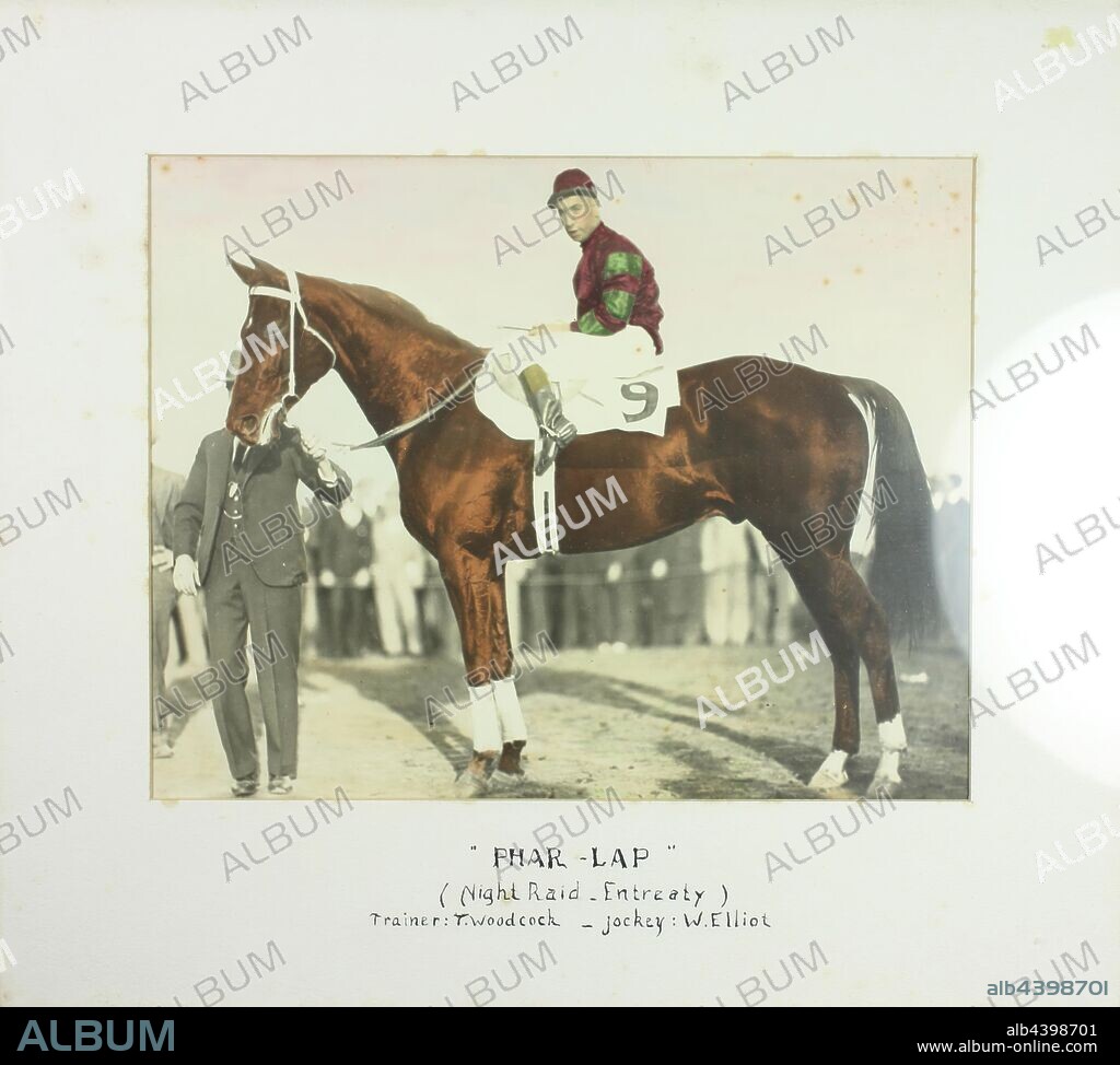 Photograph - Bill Elliot, Tommy Woodcock & Phar Lap at the Agua Caliente Handicap, Framed, 20 Mar 1932, Framed hand coloured photograph of Bill Elliot sitting on the back of Phar Lap after the running of the Agua Caliente Handicap race in March, 1932. Trainer Tommy Woodcock is holding his reins, although his face is obscured by the horse.