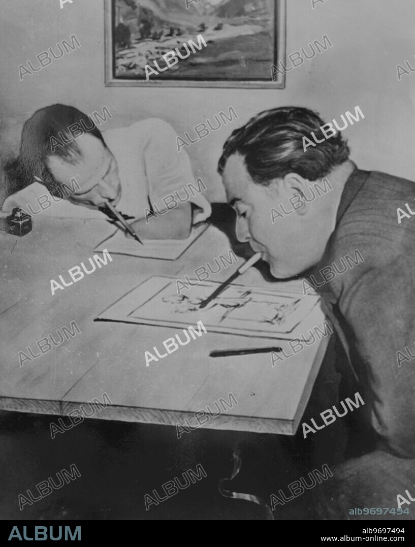 Disabled artists Bruno Schmitz-Hochburg (left) writing a letter with a pen held in his mouth while Arnulf Erich Stegmann ( right) finishes off a crayon sketch. 23 March 1950.