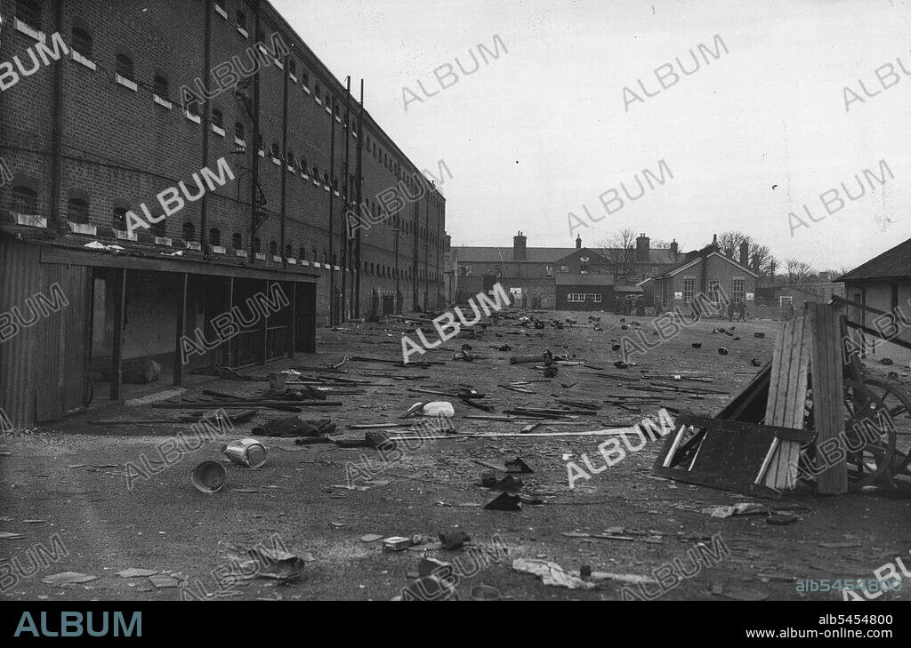 Soldiers Riot At Aldershot Detention Barracks -- Debris, including bedding, and equipment, prison fittings and cooking utensils in the prison yard, photographed today (Sunday). Military prisoners in Aldershot detention barracks last night started to riot. Some climbed to the roof of the main building end Firemen had to deluge them with water. They caused damage to the building in which they were held, smashing glass windows in the roof and skylight. February 24, 1946.