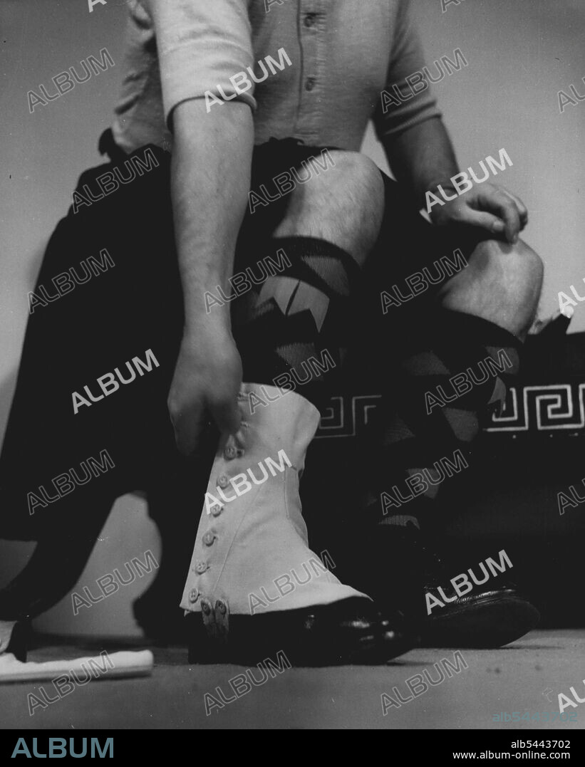 The Bandmaster Of The Black Watch Puts On His Gala Uniform : Spats -- Square-toed spats with nine buttons go over shoes and hose. They are balanced with pipe clay before each occasion. November 05, 1951. (Photo by Tom L. Blau, Camera Press).