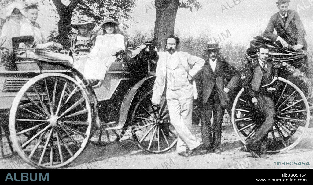 Benz, in white suit, on family outing with one of his first cars. Karl Friedrich Benz (November 25, 1844 - April 4, 1929) was a German engine designer and engineer, generally regarded as the inventor of the first automobile powered by an internal combustion engine, and together with Bertha Benz, pioneering founder of the automobile manufacturer Mercedes-Benz. Other German contemporaries, Gottlieb Daimler and Wilhelm Maybach working as partners, also worked on similar types of inventions, without knowledge of the work of the other, but Benz received a patent for his work first, and, subsequently patented all the processes that made the internal combustion engine feasible for use in an automobile. In 1879, his first engine patent was granted to him, and in 1886, Benz was granted a patent for his first automobile. In 1926, Benz & Cie. and DMG merged as the Daimler-Benz company. A new logo was created, consisting of a three pointed star (representing Daimler's motto: "engines for land, air, and water") surrounded by traditional laurels from the Benz logo, and the brand of all of its automobiles was labeled Mercedes Benz. Benz was a member of the new Daimler Benz board of management for the remainder of his life. He died in 1929 at the age of 84 from a bronchial inflammation. No photographer credited, undated.