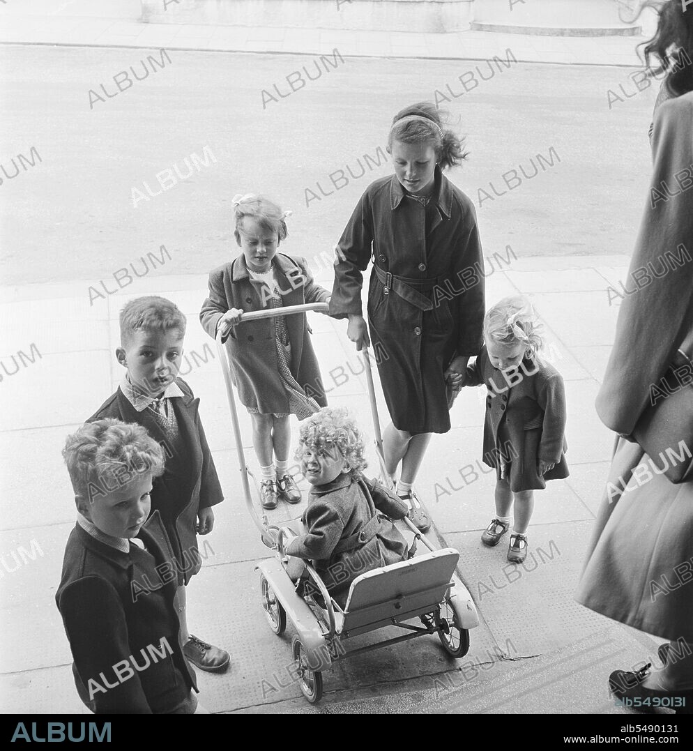 JOHN LAING PLC. Bridlington, East Riding of Yorkshire, 18/06/1949. A group of children with a small child in a pram on a day trip of Laing staff and families to Bridlington. On 18th June 1949, Laing staff from the North East area went on a day trip to Bridlington. The contracts taking part in this outing were Leicester, East Leake, Bolton on Dearne, Stubbs Wood, Office Site, Doncaster, Huddersfield, Carrington's Coppice and Darlington. Mr W. K. Laing and his wife also joined the trip.