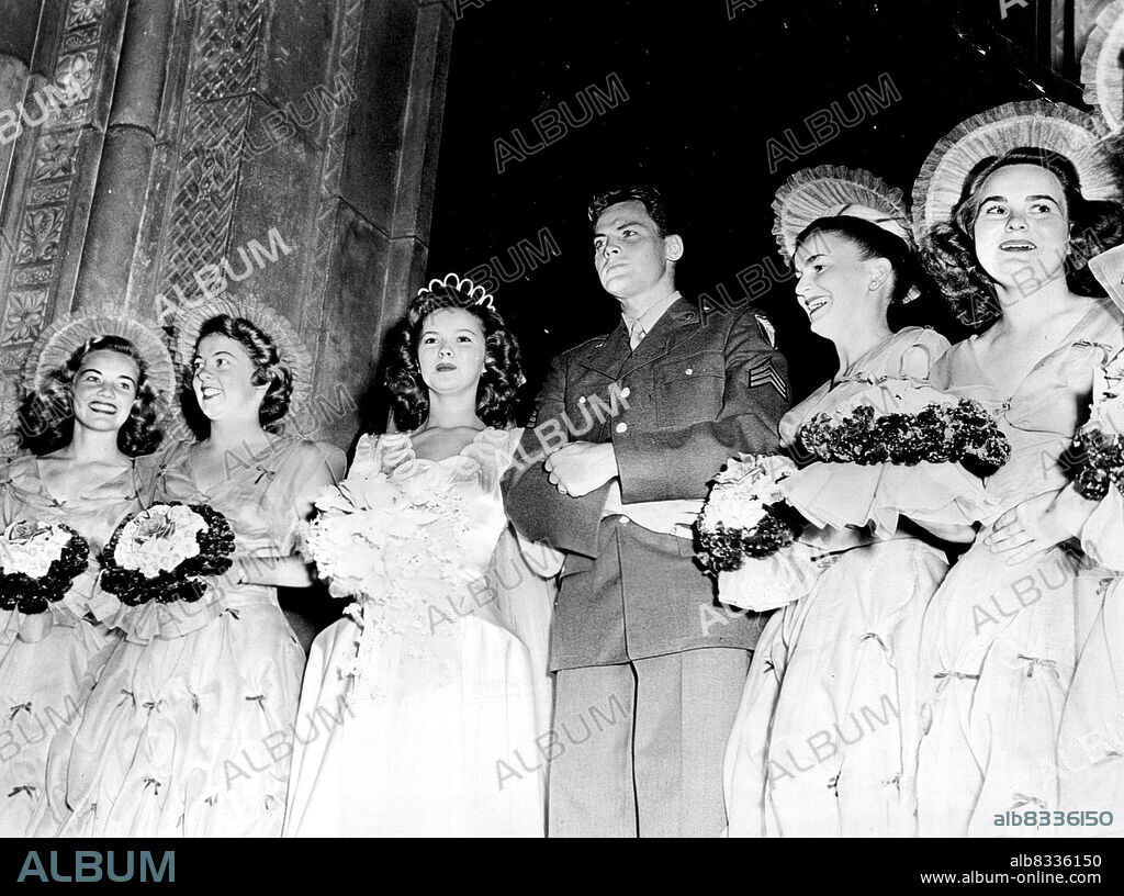 Bridesmaids Mary Lou Isleb (Shirley's standing), Catherine Ferguson (daughter of Shirley's secretary), Shirley Temple, Jack Agar, Matron of Honor Mrs. Jack Temple and Joyoe Agar shown at Shirley and Jack's wedding on September 19. February 14, 1946.