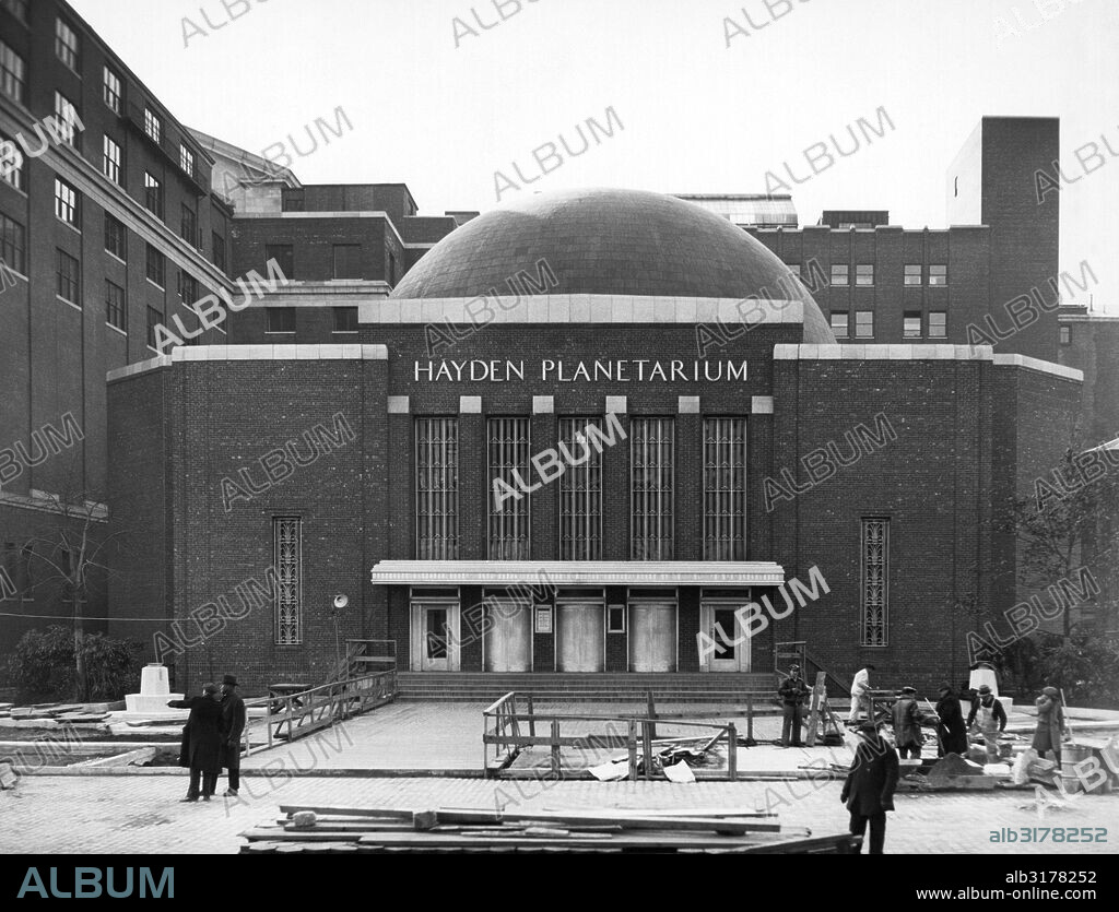 New York, New York:  1935 The Hayden Planetarium in Central Park with workers putting the finishing touches on the entry way.   © Underwood Archives / The Image Works.