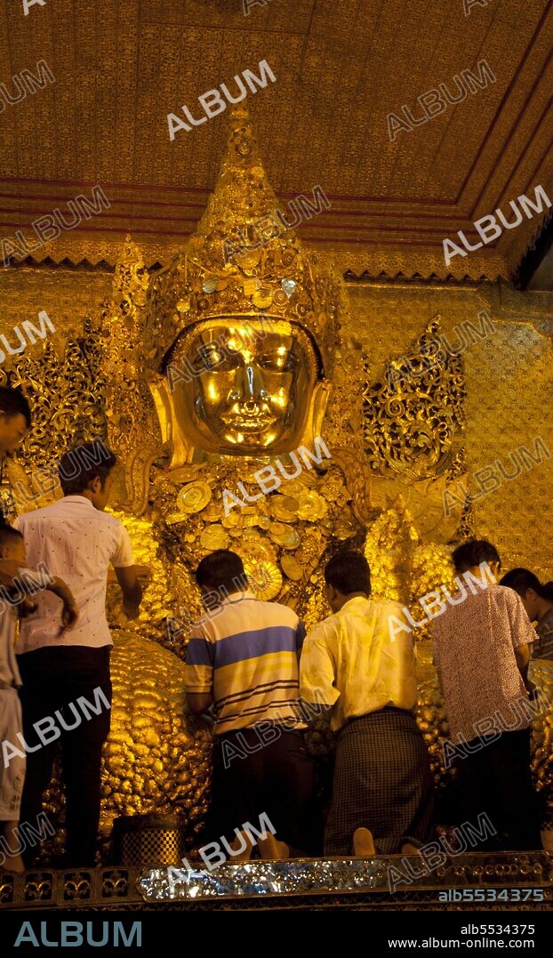 The Mahamuni Buddha Temple, also called the Mahamuni Pagoda, is a Buddhist temple and major pilgrimage site, located southwest of Mandalay, Burma (Myanmar). The Mahamuni Buddha image (literal meaning: The Great Sage) is deified in this temple, and originally came from Arakan. It is highly venerated in Burma and central to many people's lives, as it is seen as an expression of representing the Buddha's life. Ancient tradition refers to only five likenesses of the Buddha, made during his lifetime; two were in India, two in paradise, and the fifth is the Mahamuni Buddha image in Myanmar. According to legend, the Buddha visited the Dhanyawadi city of Arakan in 554 BCE. King Sanda Thuriya requested that an image was cast of him. After casting the Great Image, the Buddha breathed upon it, and thereafter the image became the exact likeness of the Mahamuni.
