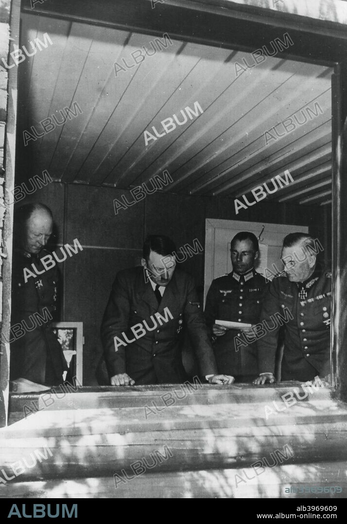 Adolf Hitler during the invasion of France, World War II, 1940. Hitler studying maps at his headquarters flanked by General Alfred Jodl, Chief of Operations Staff, Major Deile and General Wilhelm Keitel.