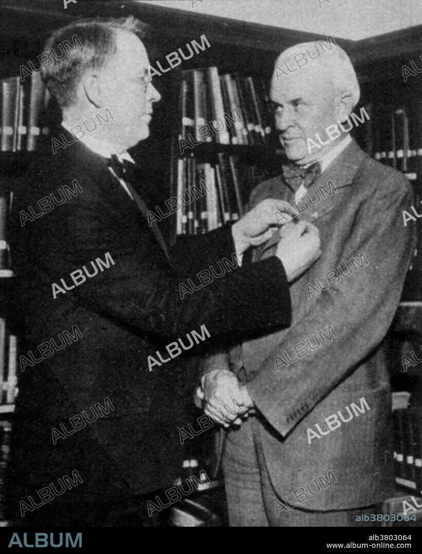 Millikan receiving the Gold Medal of the Radiological Society of North America from Robert J. May for his work in the field of x-rays, December 20, 1930. Robert Andrews Millikan (March 22, 1868 - December 19, 1953) was an American experimental physicist. In 1908, while a professor at the University of Chicago, he began experiments in which he measured the charge on a single electron. He and his graduate student Harvey Fletcher used the oil-drop experiment to measure the charge of the electron (as well as the electron mass, and Avogadro's number, since their relation to the electron charge was known). Millikan took sole credit, in return for Fletcher claiming full authorship on a related result for his dissertation. Millikan went on to win the 1923 Nobel Prize for Physics, in part for this work, and Fletcher kept the agreement a secret until his death. Millikan is also credited with measuring the value of Planck's constant by using photoelectric emission graphs of various metals. He left the University of Chicago to become Caltech's chairman of the executive council. He served in that position from 1921-45. At Caltech most of his scientific research focused on the study of cosmic rays (a term which he coined). He died of a heart attack at his home in 1953 at the age of 85.