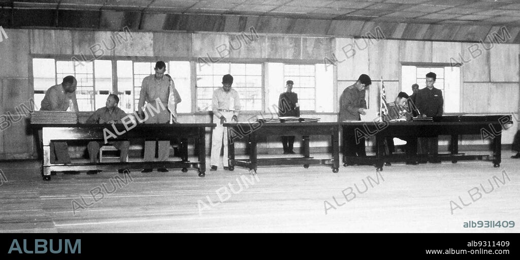 Korean War: the Korean War armistice agreement, July 27,1953. UN delegate Lieut. Gen. William K. Harrison, Jr. (seated left), and Korean People's Army and Chinese People's Volunteers delegate Gen. Nam Il (seated right) signing the Korean War armistice agreement at Panmunjeom, Korea, July 27, 1953.