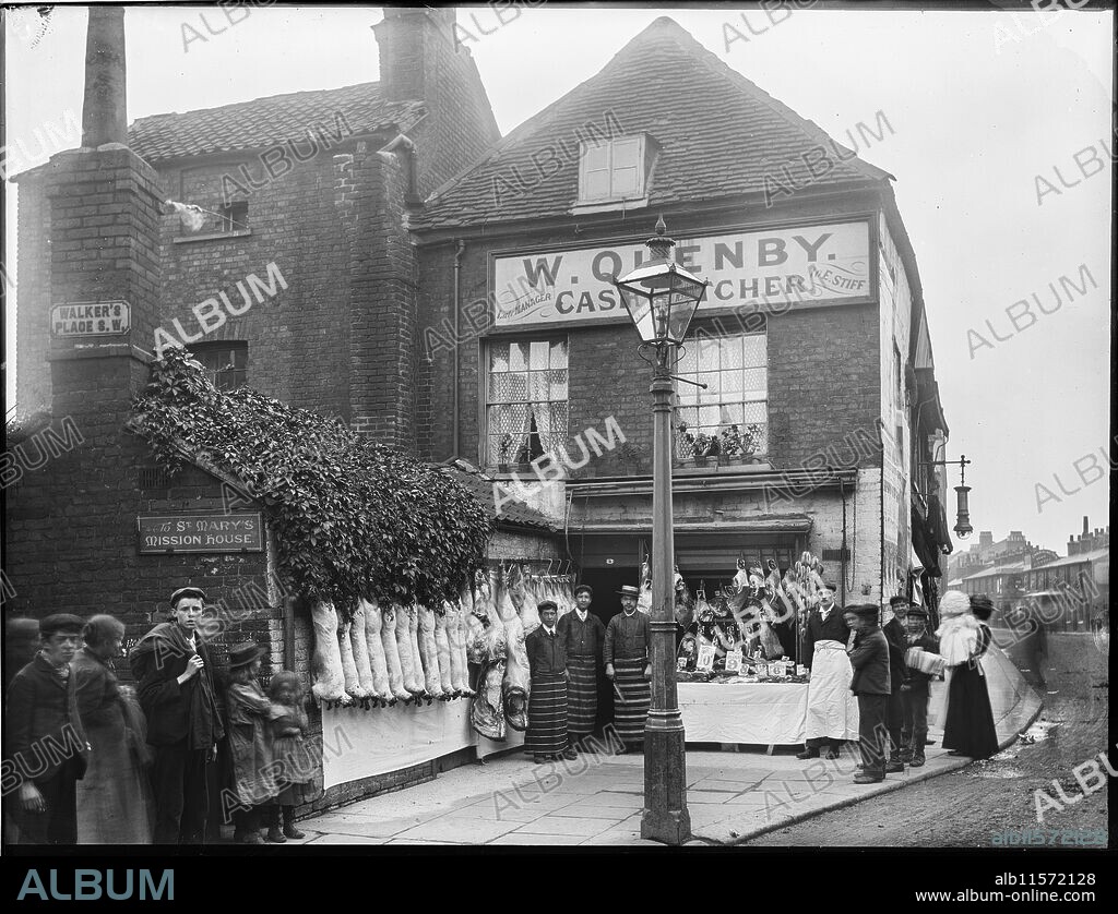WILLIAM O FIELD. W Quenby Cash Butcher, Felsham Road, Putney, Wandsworth, Greater London Authority, 1902. People posed outside the premises of W Quenby, 'Cash Butcher' on Felsham Road with the entrance to Walker's Place in the foreground. This photograph appears in 'William Fields's Photographs of Putney', compiled by Dorian Gerhold and Michael Bull for the Wandsworth Historical Society.
