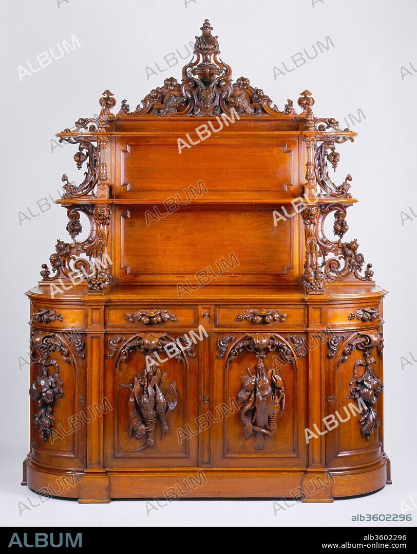 Sideboard. Culture: American. Dimensions: 92 3/4 x 71 3/4 x 25 5/8 in. (235.6 x 182.2 x 65.1 cm). Maker: Alexander Roux (1813-1886). Date: ca. 1853.
This sideboard by Aleander Roux is an "etagere" type, with an upper structure of shelves meant for the display of dining ware. Sometimes dubbed "the altar of gastronomy," the form became popular in America and Eurpoe about 1850 and remained a prominent feature of dining rooms for the next quarter century. Hunt and harvest themes prevailed. Roux displayed the prototype for this piece at the 1853 Crystal Palace Exhibition in New York. Afterward, he was commissioned to make a pair of related sideboards for the Astor family--this one and its mate, which is at the Newark Museum.