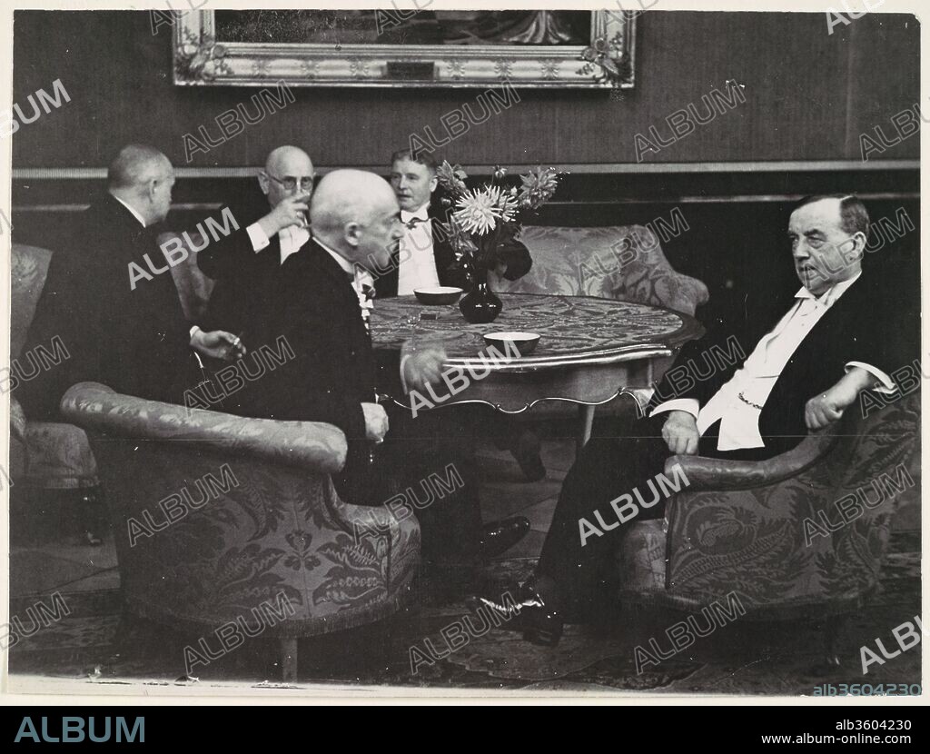 [Five Gentlemen Conversing around Table]. Artist: Erich Salomon (German, Berlin 1886-1944 Auschwitz, Poland). Dimensions: 17.4 x 23.2 cm. (6  7/8  x 9  1/8  in.). Date: 1920s-30s.
The phrase "candid camera" was first coined in 1929 to describe Salomon's idiosyncratic technique of capturing the world's most powerful political and industrial leaders revealing themselves as ordinary human beings: talking, yawning, and joking. With his 35mm Ermanox camera concealed (sometimes in a hat or suitcase) and his unobtrusive appearance, Salomon was able to cut through the slick facade conveyed by official state portraits, both deflating and humanizing the politicians he photographed. This picture was taken in the Reichskanzlei in Berlin.