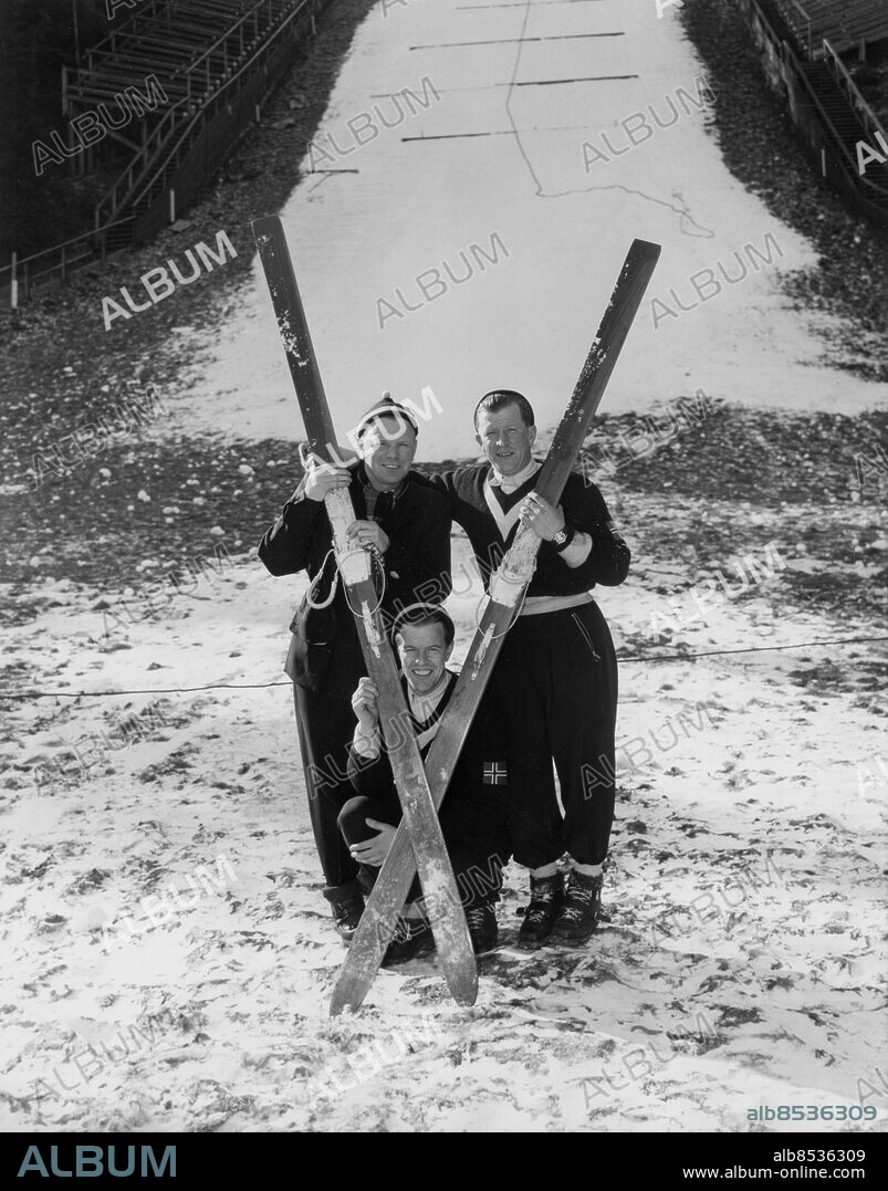 Orig. bildtext... BROTHERS ARE FAMED SKI TRIO Lake Placid, New York: L to R: Here for the 1950 World Ski Championships are the famed Ruud brothers. Sitting: Asbjorn Ruud, World Champion of '38, a competitor at Lake Placid this year: standing, L to R: Sigmund Ruud, who won U.S. national title in '37, and Burger Ruud, who is recognized as the premier jumper of all time. Birger won his first world title in 1931, and in 1932, won the gold medal in the olympic ski jumps at Lake Placid. Anm. B Ruud, 1911-1998, norsk backhoppare, världens främste på 1930-talet med bl a guld i OS 1932 och 1936. S Ruud, 1907-1994 och A Ruud, 1919-1989 VM i backhoppning 1950 Skidor Syskon CD170 persons: Sigmund Ruud ;Birger Ruud ;Asbjörn Ruud sites: USA ;LAKE PLACID ;NORGE*.