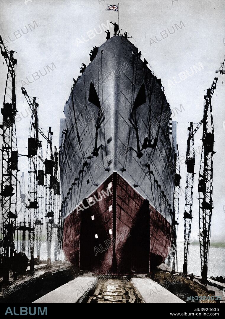 Launch of the Cunard ocean liner `Queen Mary`, 1934 (1935). The British giant liner, Cunarder No. 534, was launched on September 26th by Her Majesty, who christened the boat Queen Mary, 1909. From The Royal Jubilee Book 1910-1935 [Associated Newspapers Ltd., London, 1935]. (Colorised black and white print).