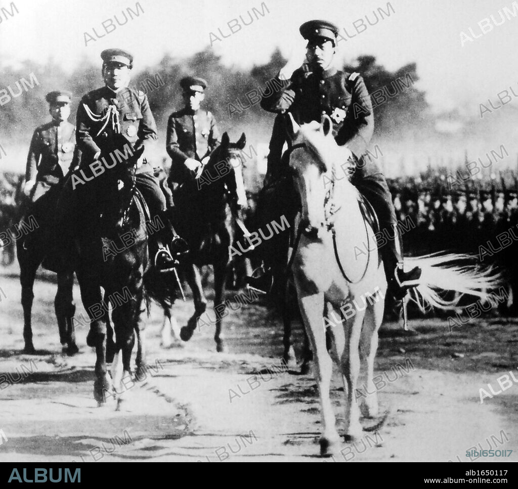 Hirohito (1901-1989) 124th Emperor of Japan (1926-1989). Emperor mounted on white horse at a review of troops, c1937.