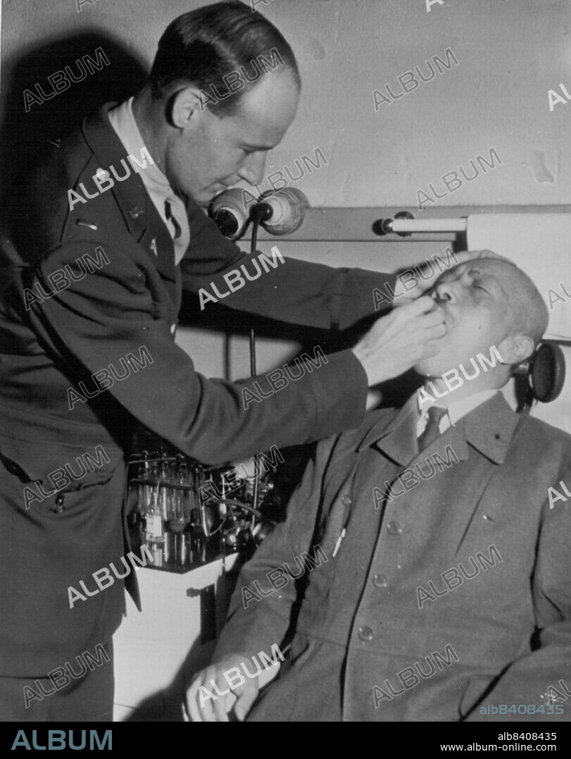 Tojo Gets a Health Check-Up -- Lt. F.X. Paul Tinker of Baltimore, Md., gives Hideki Tojo, Japan's wartime Prime Minister, a health check-up. Tojo currently is on trial on wartime criminal charges. November 06, 1946. (Photo by AP Wirephoto).