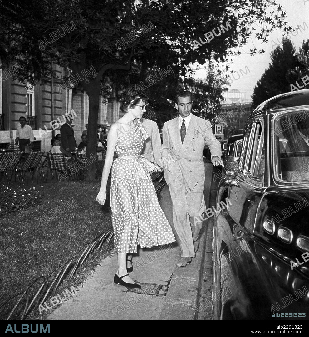 Mohammad Reza Pahlavi and the Princess Soraya of Iran. The Shah of Persia Mohammad Reza Pahlavi being about to open the car door for his wife the Princess Soraya Esfandiary Bakhtiari of Iran on via Veneto. Rome, 1953.