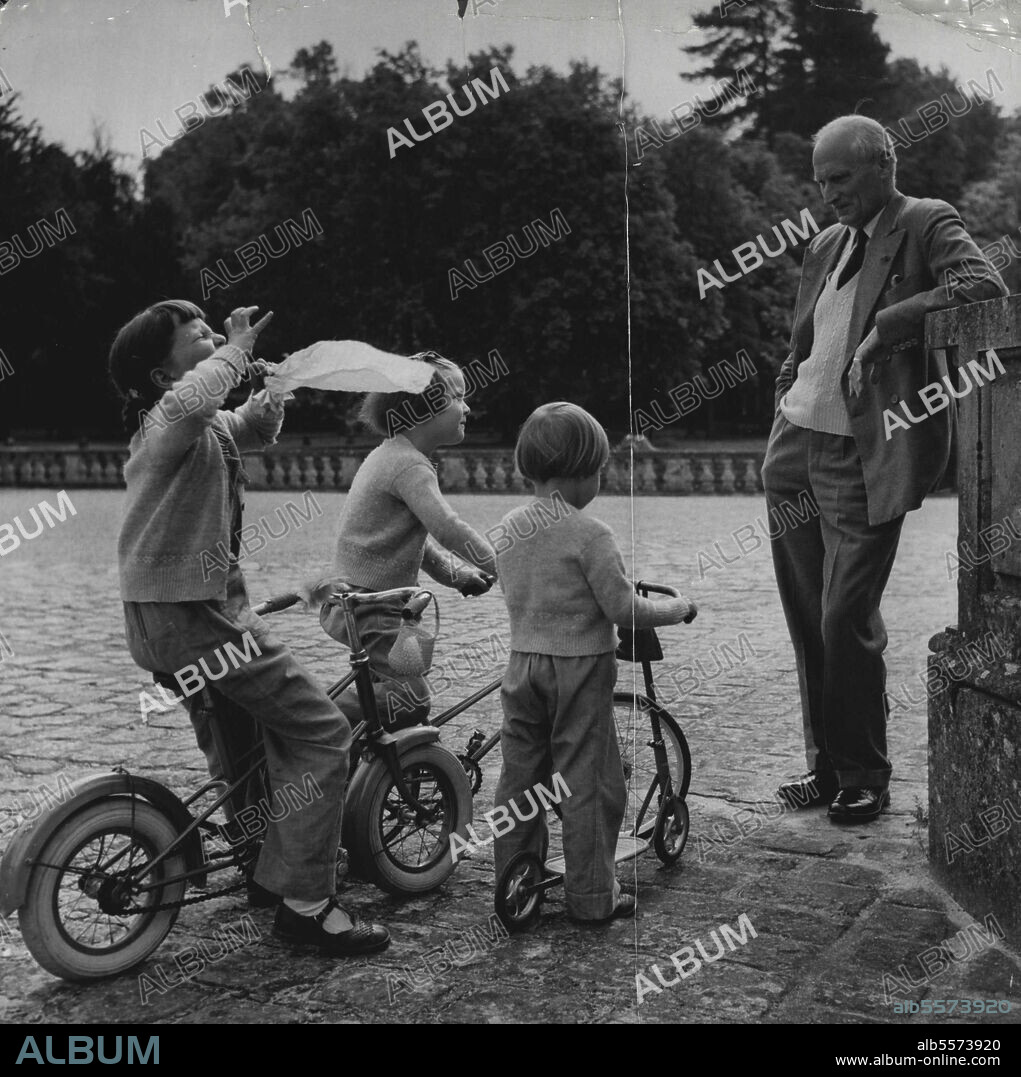 Field Marshal Montgomery: The Field Marshal shares the Chateau de Courance with his host the Marquis de Ganay. Here the Field Marshal is seen with the grandchildren of the Marquis. They are the daughters of the Count de Ganay. They are Anne Marie aged 7 and Marin aged 5. Their father the count is a friend of the Queen and the Duke of Edinburgh and has recently spent come time at Balmoral as guest for shooting. January 10, 1955. (Photo by Jack Esten).