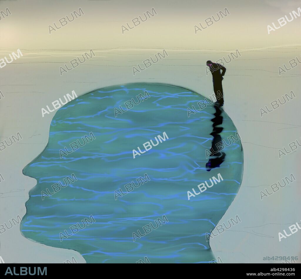 Man looking down into tranquil water inside of head profile.