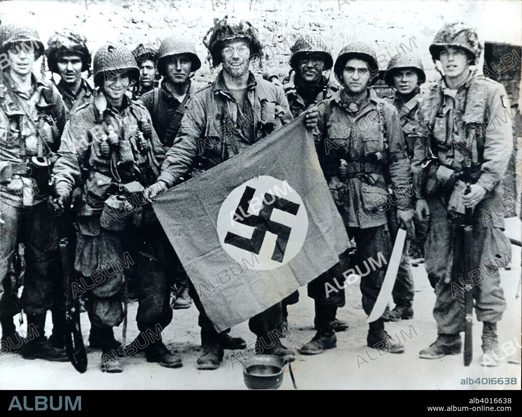 American parachute troops with a captured Nazi flag, Normandy, World War II, 6 June 1944. US Army paratroops from the 82nd and 101st Airborne Divisions were among the first Allied troops to land in Normandy on D-Day.