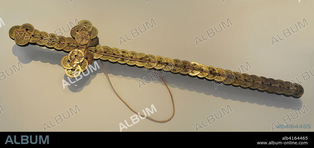 Coin-sword. This kind of swords were designed to ward off evil spirits and bring good luck and health. 18th century. Bronze. Length: 53 cm, maximum width: 11.50 cm. From China. National Archaeological Museum. Madrid. Spain.
