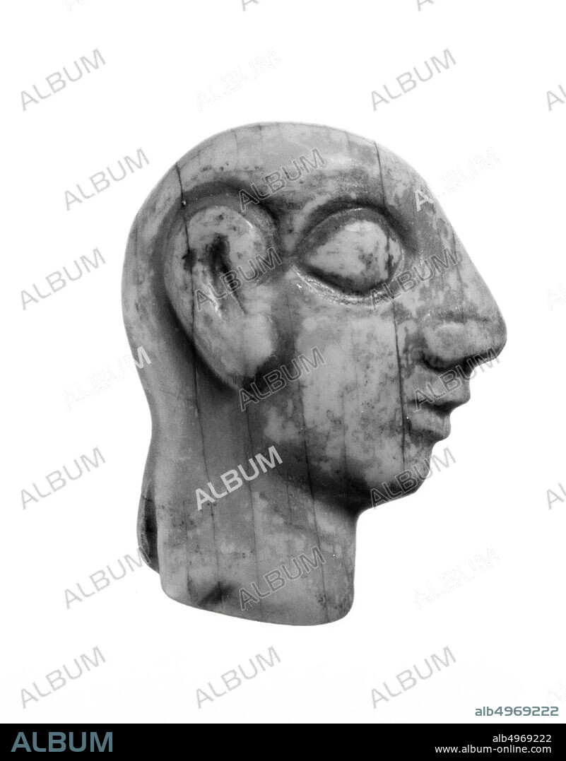 A male profile, only 2.2 cm high, is carved from ivory: the shaved head, the eye, the ear and the nose, all relatively relatively large, are characteristic of images from the early third millennium B.C. in Mesopotamia and Syria. It was probably part of a larger panel with marquetry, decorative plate, furniture, organic, ivory, H 2.2 cm, Early Bronze Age 2700-2600 BC, Iraq ?, Syria?.