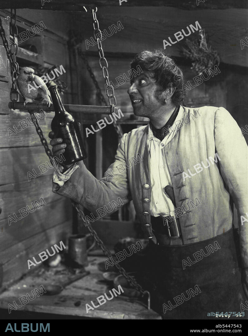 Pirate and Parrot -- Robert Newton as long John Sliver, and his parrot, Captain Flint, in a scene from "Treasure Island," the RKO Walt Disney Technicolor version of the Robert Louis Stevenson novel. The Bottle Imp, title of another Robert Louis Stevenson story, could well be used to describe Robert Newton as the roistering Long John Silver in Treasure Island. May 05, 1954.