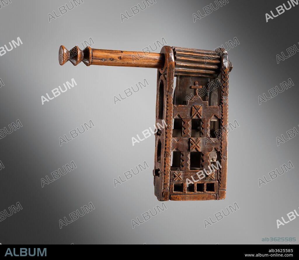 Cog Rattle. Culture: French. Dimensions: Height (Of handle and cog): 10 3/4 in (27.3 cm)
Width (Of frame): 9 1/16 in. (23 cm)
Depth: 28 9/16 in. (72.5 cm). Date: 15th or 16th century.
It was formerly the custom for the bells of Catholic churches to be silent during Holy Week, having (according to an old legend) "flown to Rome" for that period.  Accordingly, the bells were replaced during the celebration of the Mass by another instrument, and this was the cog rattle - a noisemaker that produces a loud, rattling sound when whirled around its handle.
