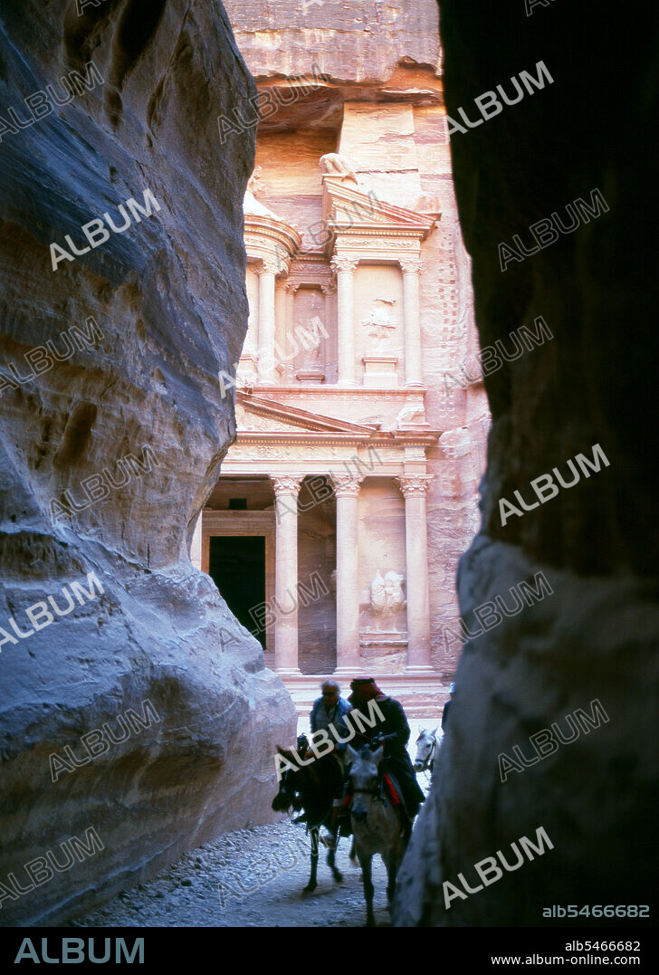 The Siq or al-Siq (translated: the shaft) is the main entrance to the ancient city of Petra in southern Jordan. The dim, narrow gorge (in some points no more than 3 meters wide) winds its way approximately one mile and ends at Petra's most elaborate ruin, Al Khazneh (The Treasury). Petra was first established as a city by the Nabataean Arabs in the 4th century BCE, and owed its birth and prosperity to the fact that it was the only place with clear and abundant water between the Hijaz trading centres of Mecca and Medina, and Palestine. Hewn directly into the Nubian sandstone ridges of the south Jordanian desert, it seems probable that - given its excellent defensive position and good water supplies - Petra has been continually occupied from as early as Paleolithic times. It is thought to be mentioned in the Bible as Sela, a mountain fortress captured by Amaziah, King of Judah, in the 9th century BC, when the defenders were hurled to their deaths from the summit, and as many as 10,000 people died. The city's Latin name, Petra - literally, 'Rock' - probably replaced the biblical name Sela at the time of the Roman conquest some 1,900 years ago. Today, in Arabic, the ancient site is still called Batraa, though the valley in which it is situated is known as Wadi Musa - 'The Valley of Moses' - being one of the places where, according to semitic tradition, the Prophet Moses struck a rock and water gushed forth. Truly Petra is steeped in history.
