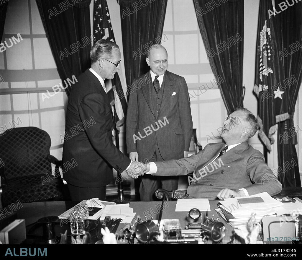 Washington, D.C.: February 18, 1938. President Roosevelt congratulates Joseph P. Kennedy after he took the oath from Associate Justice Stanley Reed as the new U.S. envoy to Great Britain.  © Underwood Archives / The Image Works.
