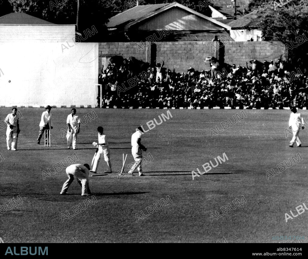 Neil Harvey bowled by Collie Smith.While players accept obvious out non chalantly, barracker in background takes no chances, shouts loud appeal to umpire. The dismissed batsman is Neil Harvey. March 28, 1955.