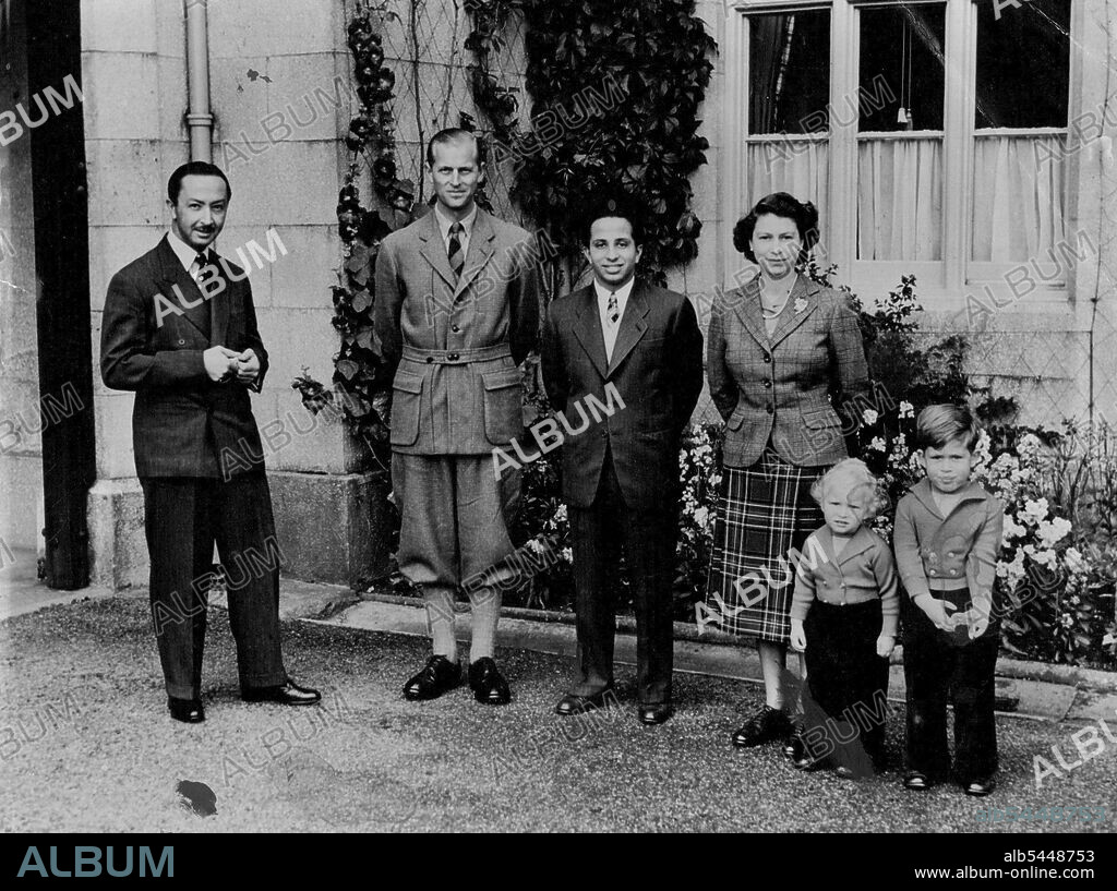 The Queen With Her Royal Visitors At Balmoral - The Queen, wearing a tartan skirt and tweed jacket, photographed outside Balmoral Castle with her royal guest, King Faisal II of Iraq, the Duke of Edinburgh, Princess Charles and Princess Anne, and, on left, the Regent of Iraq. Princess Charles and Princess Anne are Cosily warm in long trousers and double-breasted cardigans, while their father favours a shooting jacket and plus fours. September 26, 1952. (Photo by Reuterphoto).