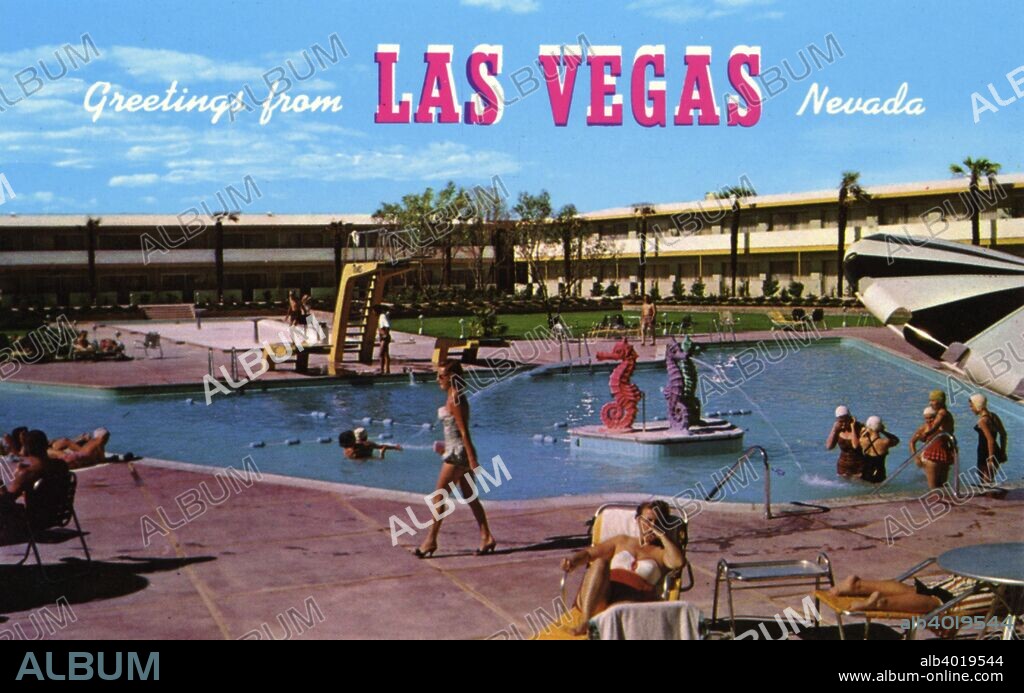 The Dunes Hotel, Las Vegas, Nevada, USA, 1956. Vintage postcard showing the pool side of the Dunes Hotel. The pool has a diving board and seahorse fountain. Guests lounge on the surrounding patio and enjoy the water. The tenth casino hotel to be built on The Strip, the Dunes opened in 1955. It closed in 1993 and the Bellagio now stands on the site.