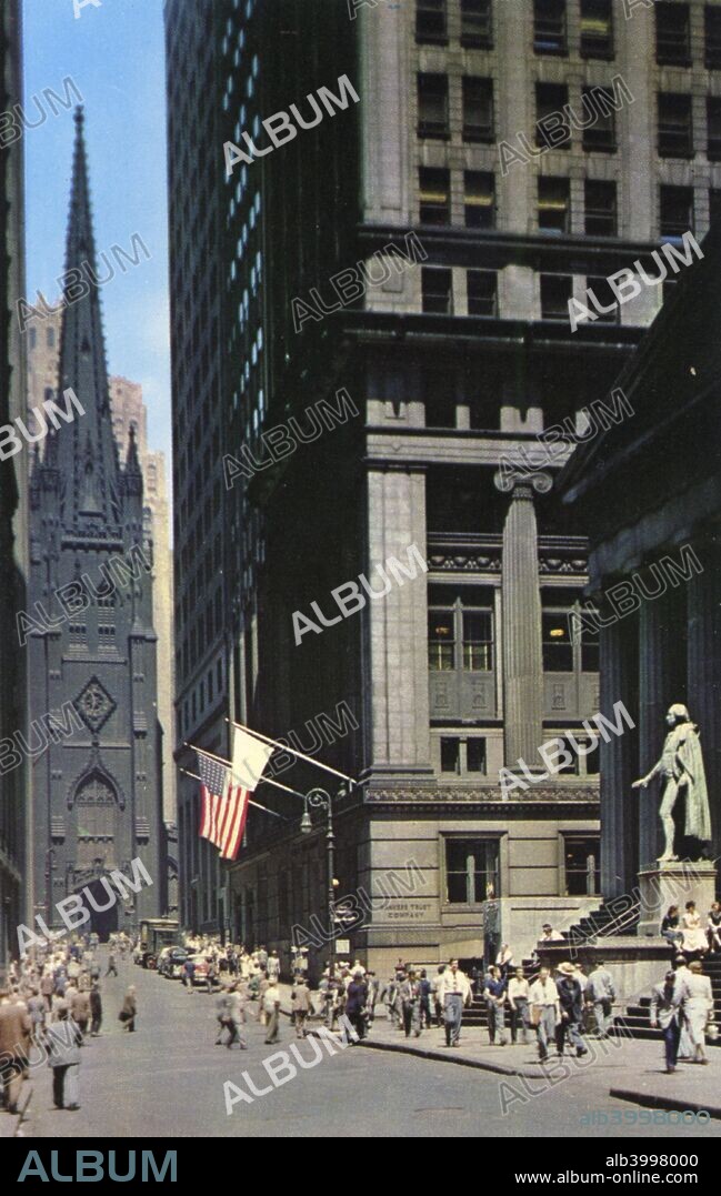 Wall Street, centre of the financial district, New York City, New York, USA, 1956. Vintage postcard showing the view down Wall Street to the Gothic Revival Trinity Church, designed by Richard Upjohn and built in 1846. The statue of George Washington stands on the steps of Federal Hall, commemorating the spot where he was inaugurated as the first President of the United States.