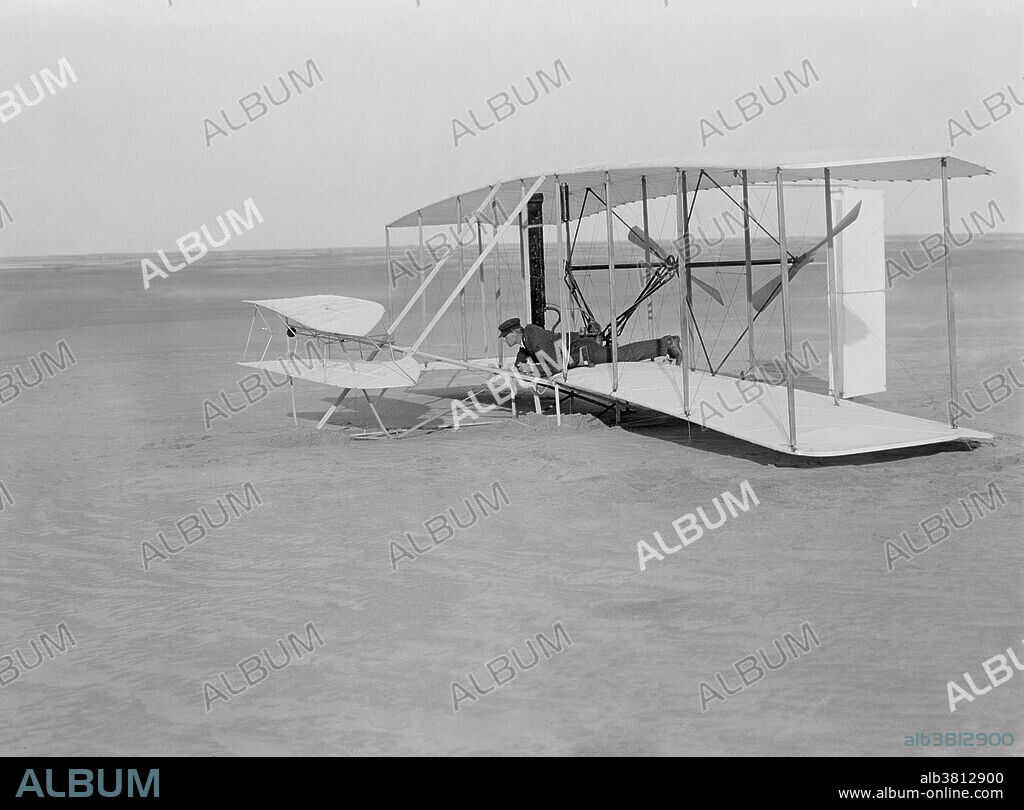 Wright Flyer. Wilbur Wright crash landing the Wright Flyer on December 14 1903. This trial flight actually left the ground and only slightly damaged the aircraft. Following repairs the first powered flight took place on 17th December, covering 36.6 meters. Photographed at Kill Devil Hill, Kitty Hawk, North Carolina, USA.
