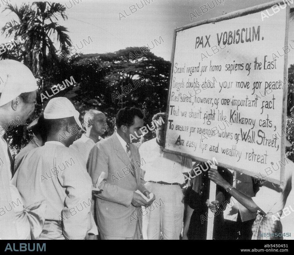 uNixon Talks With Anti- American Demonstrators -- Vice President Richard M. Nixon, center, looks at anti-American sign held by leftist demonstrators at Pegu, Burma, 40 miles northwest of Rangoon, Nov.26. Nixon, passing through the ancient city during his world tour, insisted on walking among the demonstrators and talking with them. His discussion with the leader of the gathering was friendly and there was hand shaking all around when Nixon departed. December 05, 1953. (Photo by AP Wirephoto).