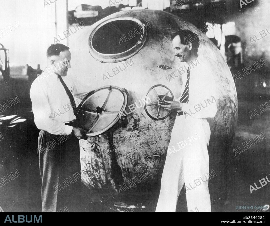 Professor Jean Piccard And Commander Settle Make Stratosphere Ascent -- Professor Jean Piccard (right) and Lieut. Commander T.G.W. Settle inspecting their gondola.Professor Jean Piccard and Lieut. Commander T.G.W. Settle of the United States Navy were scheduled to make their journey into the stratosphere. Professor Piccard is a twin brother of Professor Auguste Piccard who ascended to a height of ten miles last year. This time it is hoped to reach a height of 17 miles over Chicago in a special gondola. July 19, 1933.