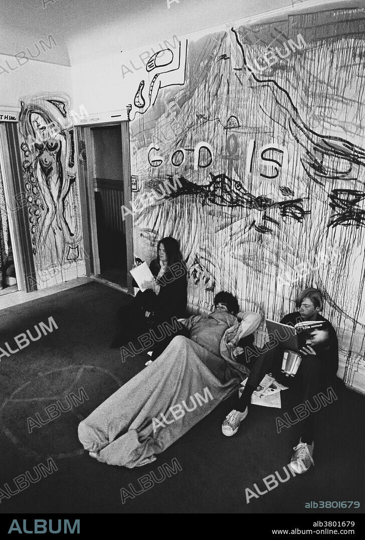 Crash pad in Haight Ashbury, San Francisco, circa 1970s.  The young man on the right is reading a Time-Life book on The Mind, which was published in 1971.